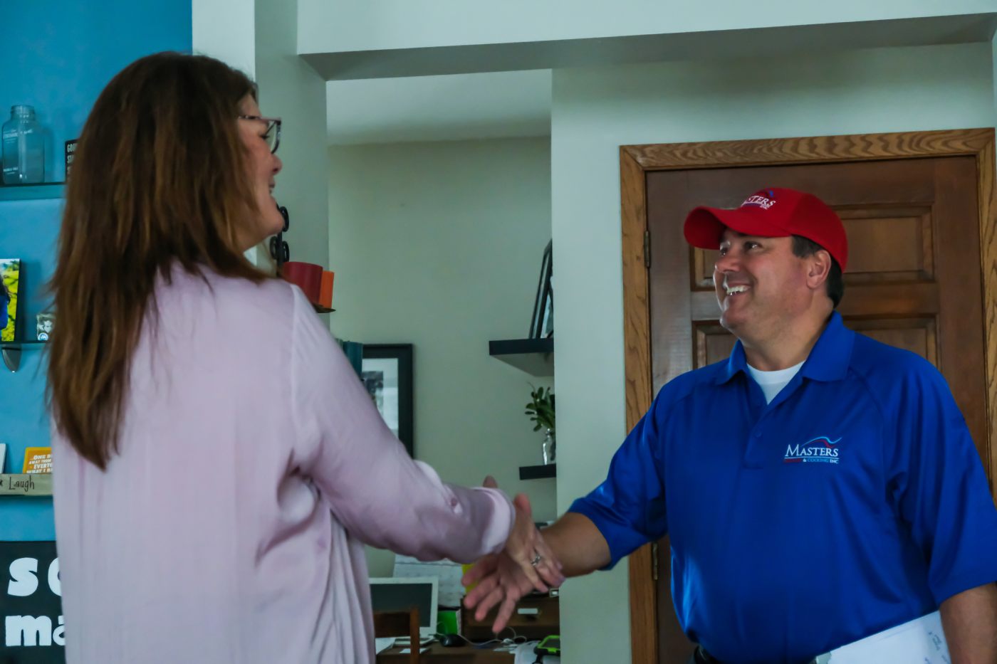 Masters Heating & Cooling technician shaking the hand of an Indiana homeowner