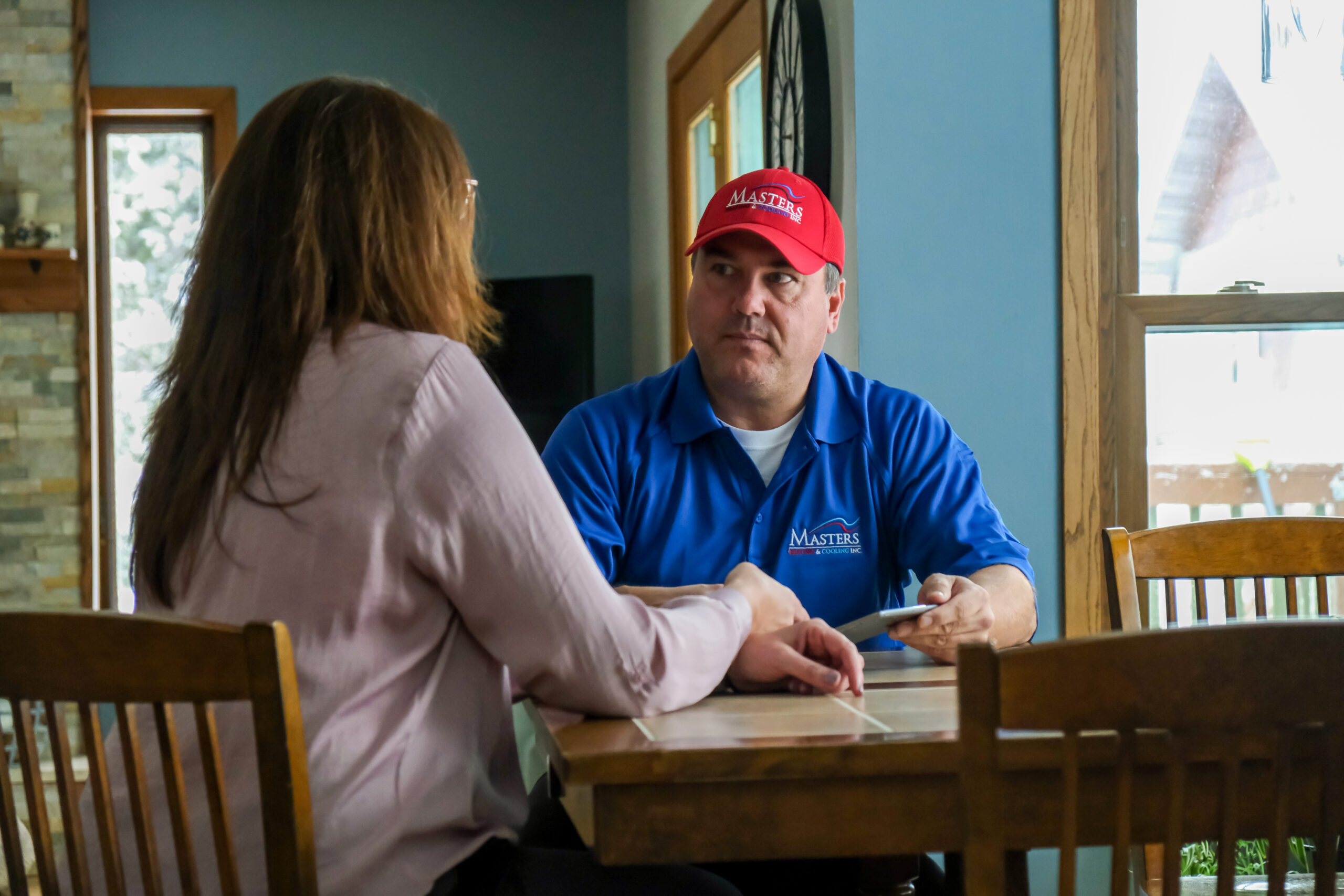 Masters Heating & Cooling technician speaking with an Indiana homeowner