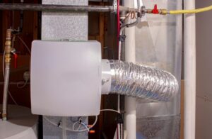 A whole-home humidifier installed in the basement of a home.