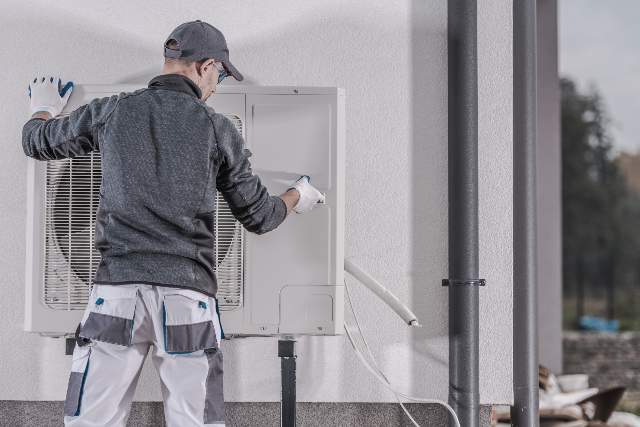 Technician replacing a home’s heat pump