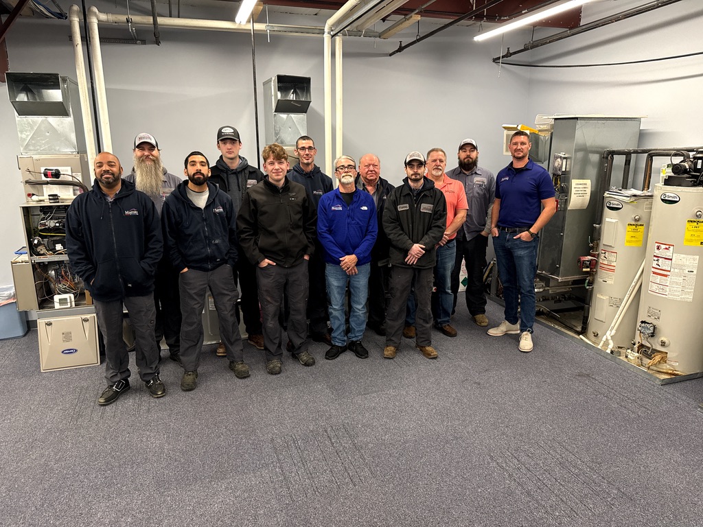 Homeowner’s hand on the temperature knob of a tankless water heater