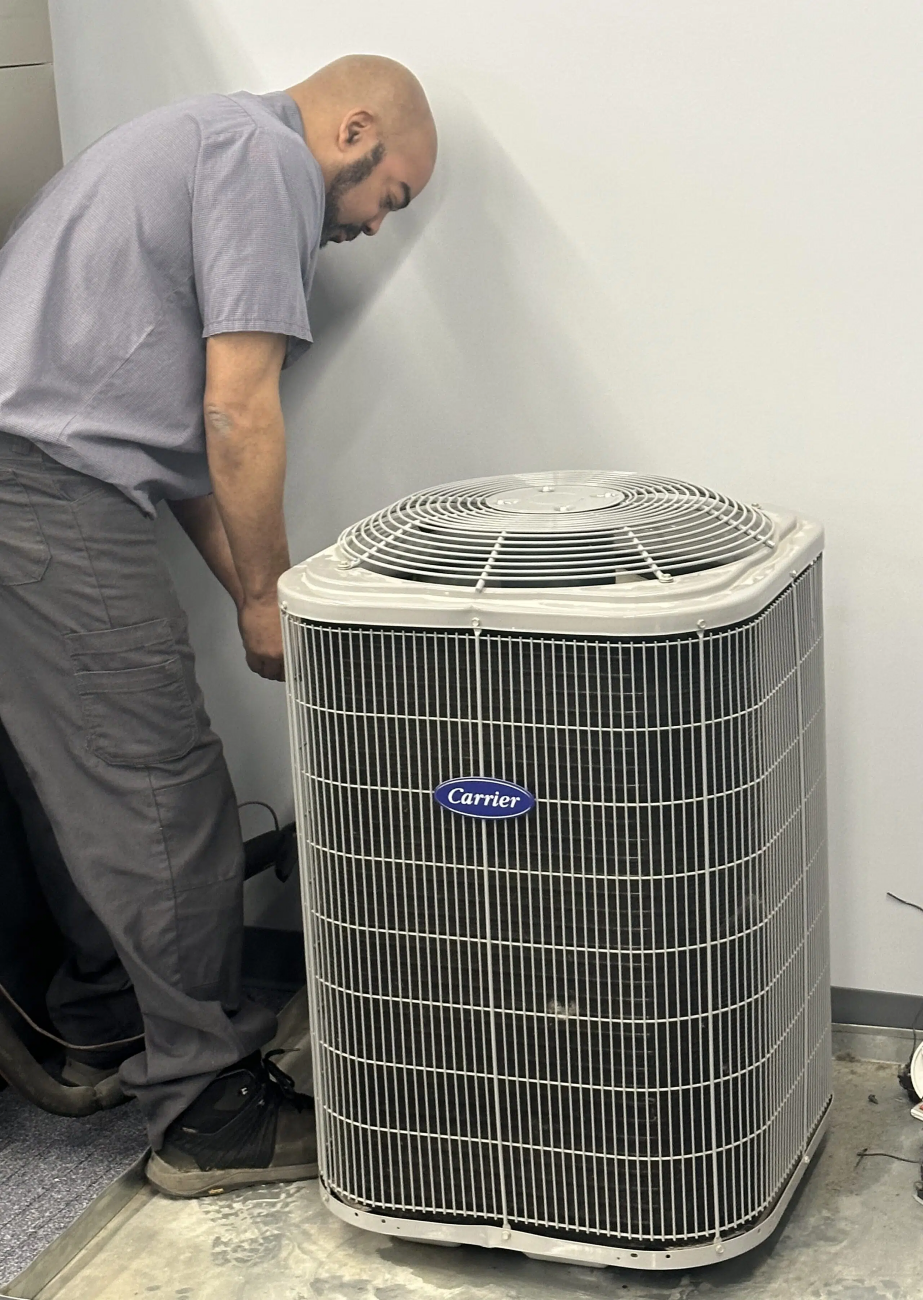 HVAC technician working on an outdoor AC unit