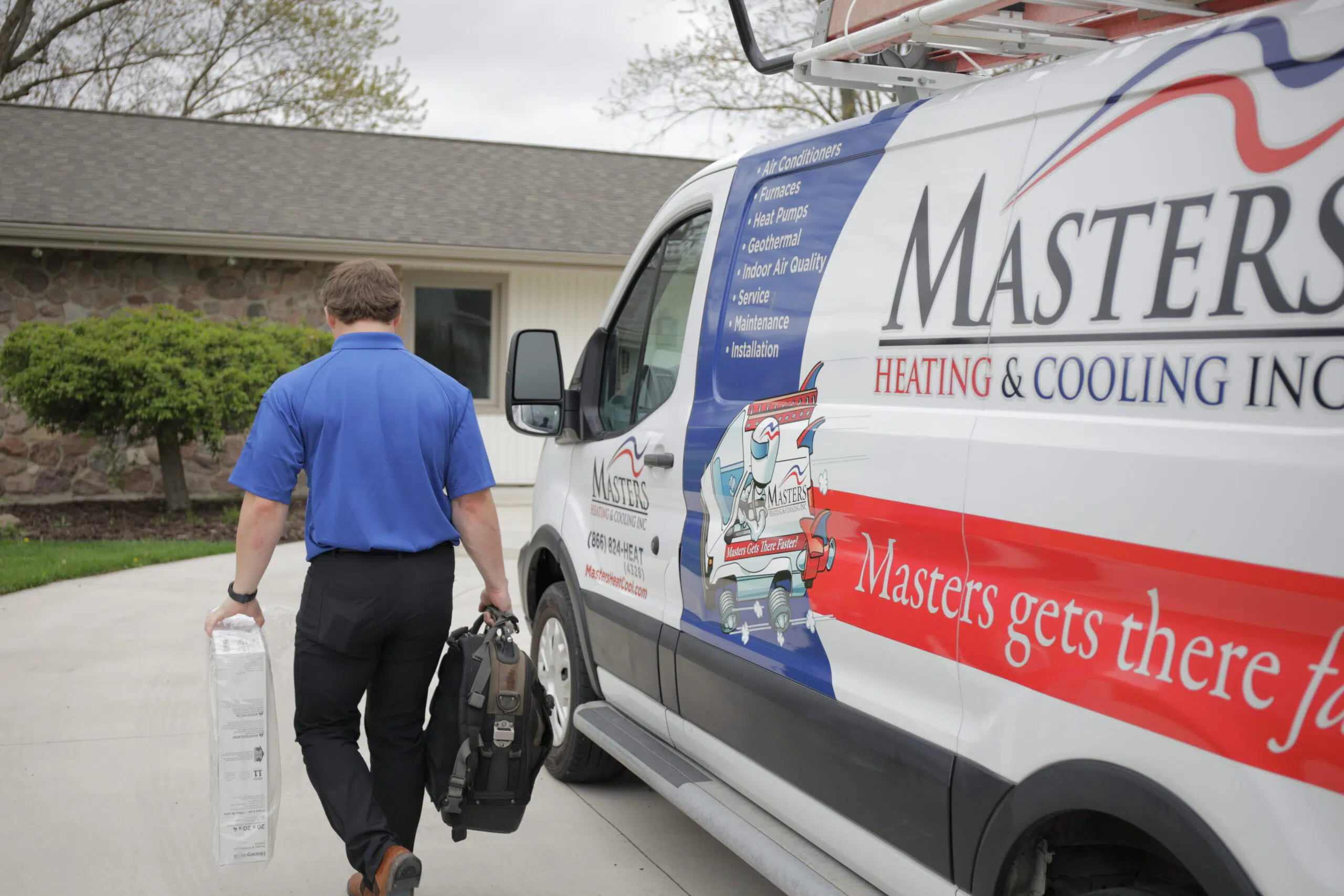 HVAC technician taking the front panel off a home’s boiler