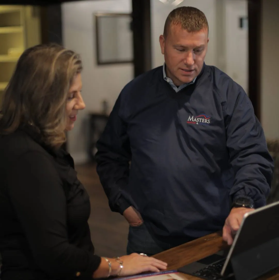 Technician replacing a home’s heat pump